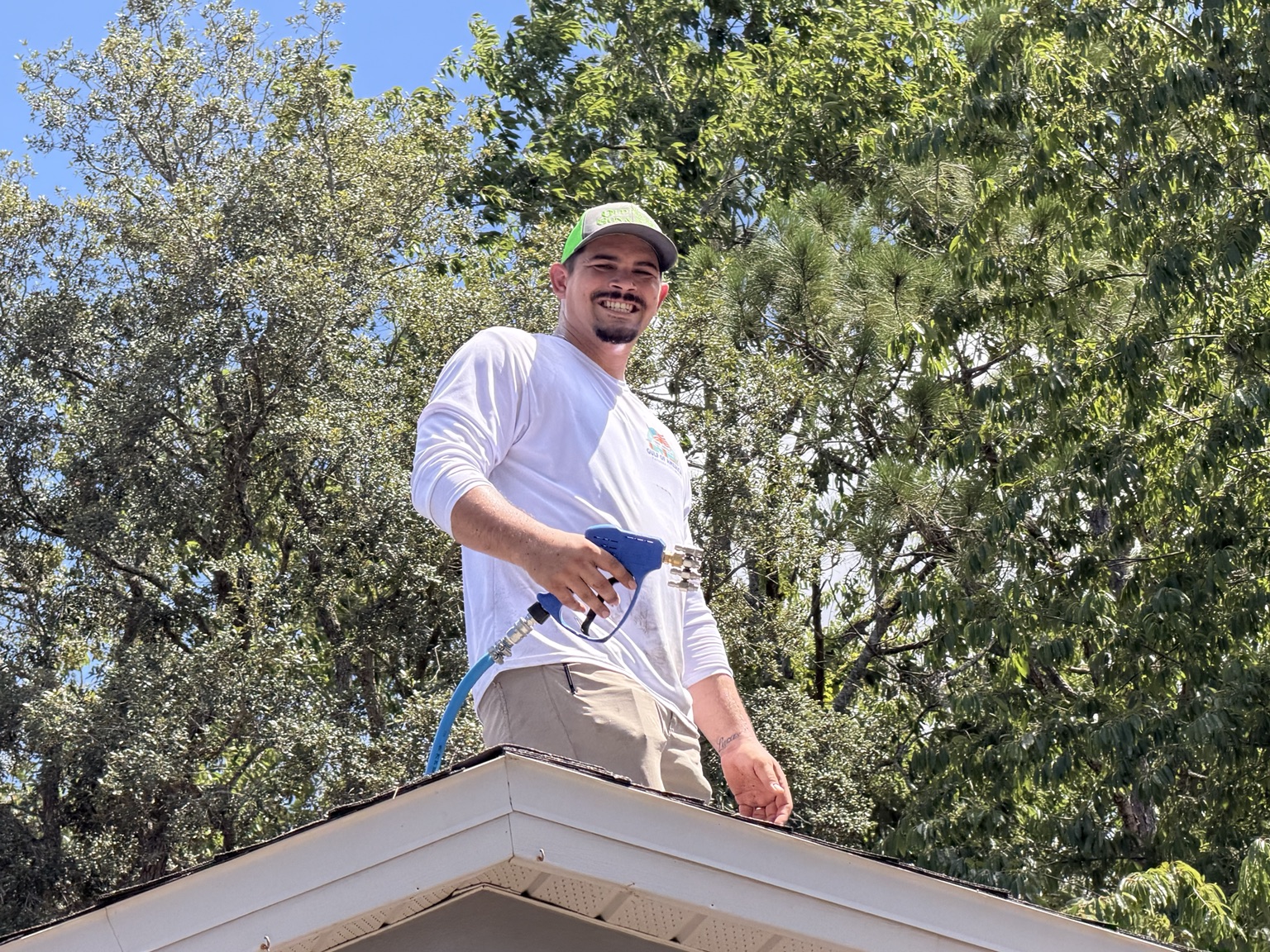 JNL Pressure Washing owner working on a roof